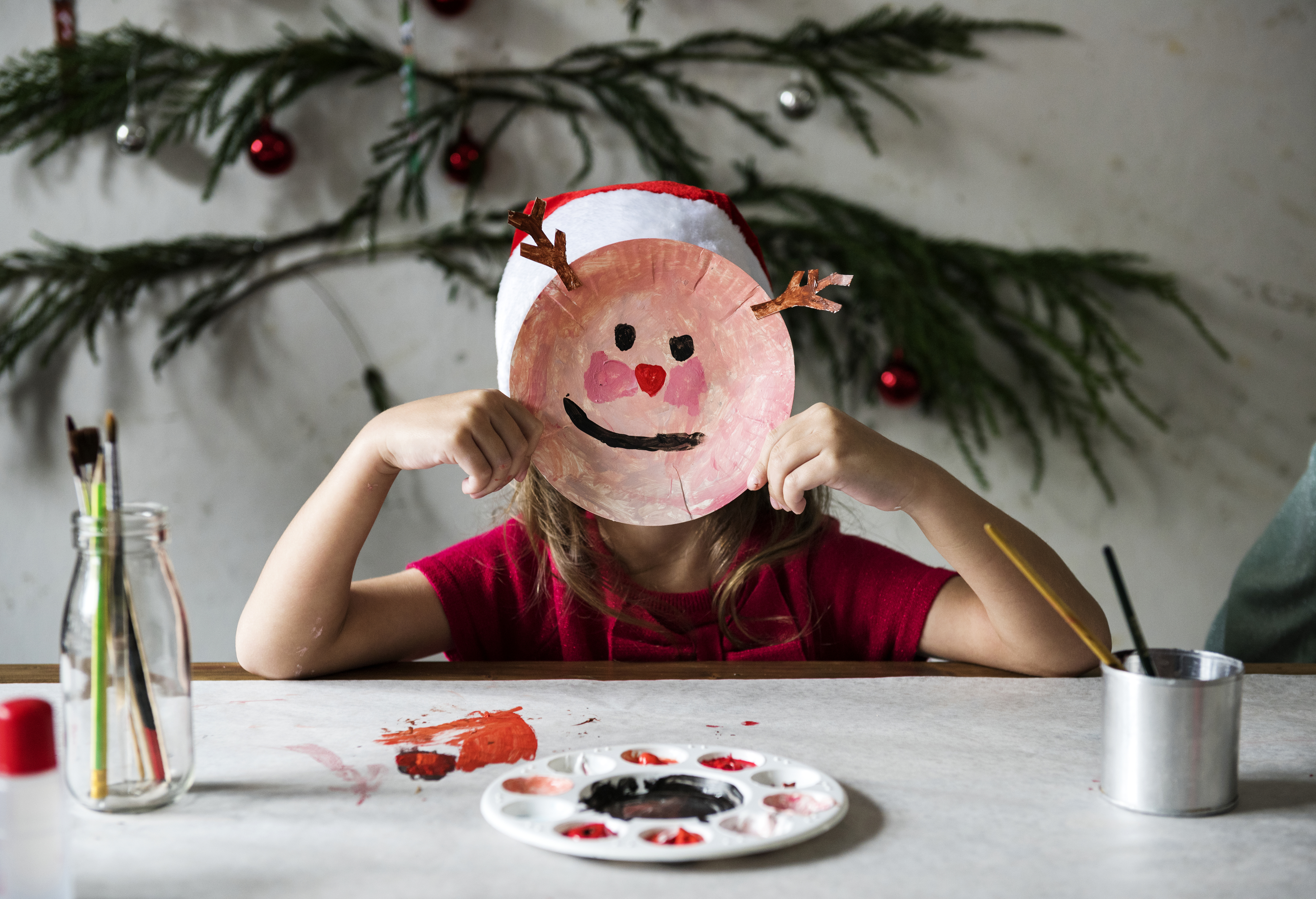 Little girl wearing a reindeer mask 